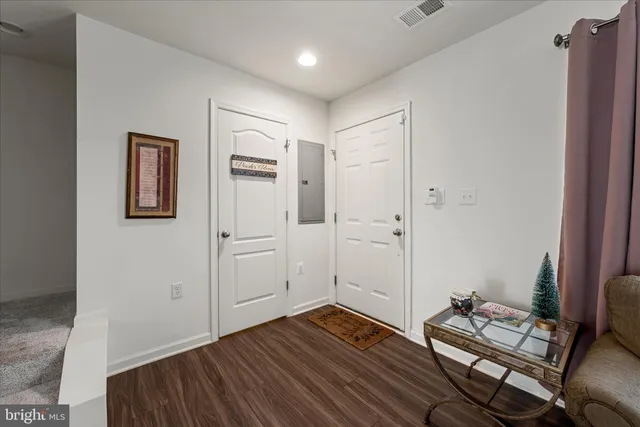 a view of room with hardwood wall and hallway