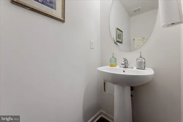 a bathroom with a sink and mirror