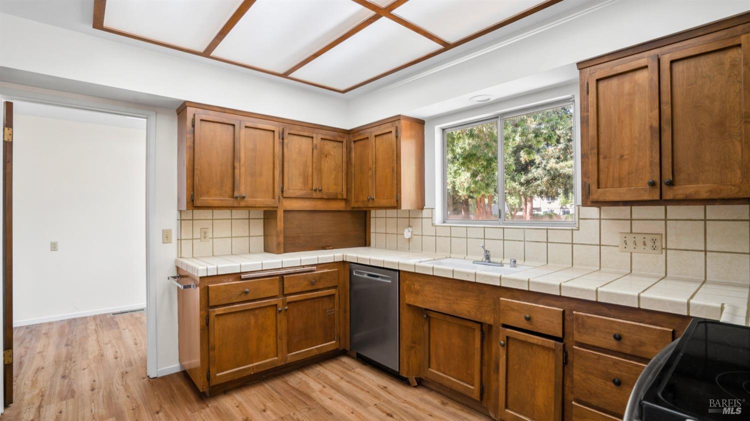 5210-5214 Fulton Road Santa Rosa, CA 95403 - Photo 11 of 60 a kitchen with a sink window and cabinets