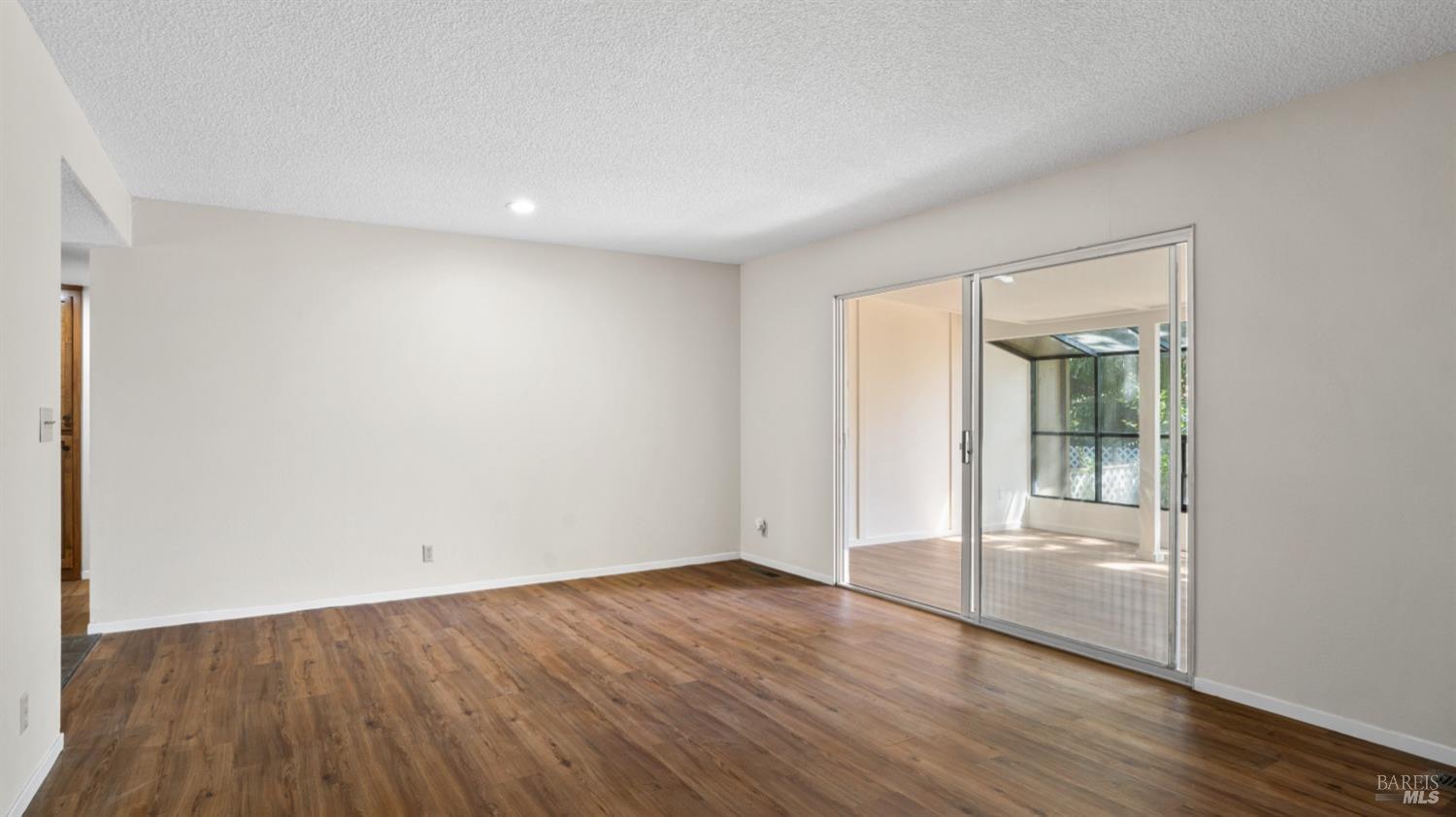 5210-5214 Fulton Road Santa Rosa, CA 95403 - Photo 14 of 60 an empty room with wooden floor and windows