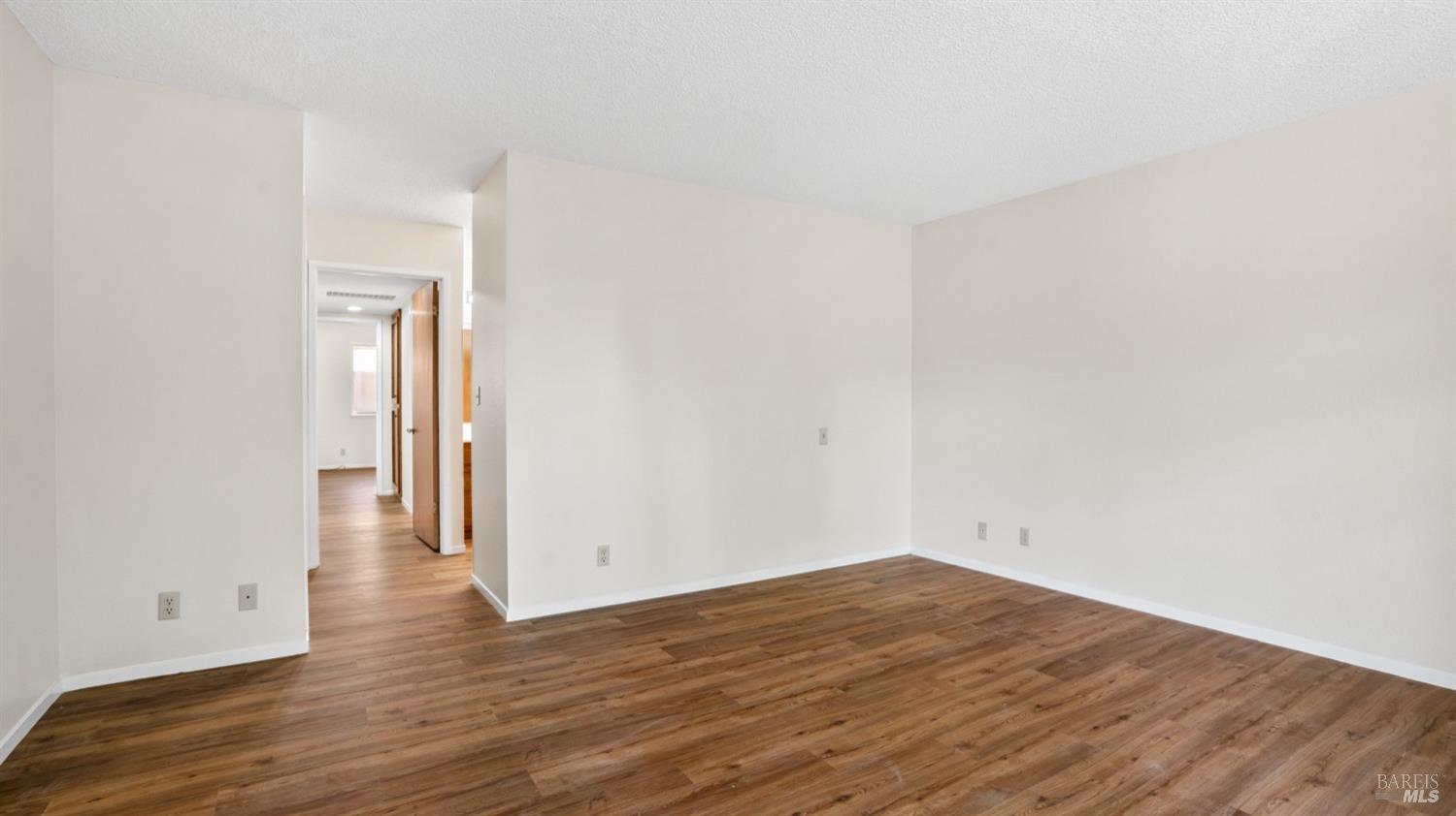5210-5214 Fulton Road Santa Rosa, CA 95403 - Photo 15 of 60 a view of a room with wooden floor and a ceiling fan