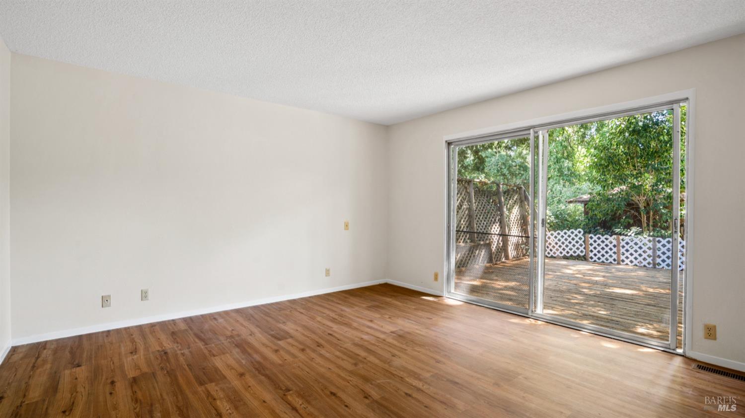 5210-5214 Fulton Road Santa Rosa, CA 95403 - Photo 16 of 60 an empty room with wooden floor and windows