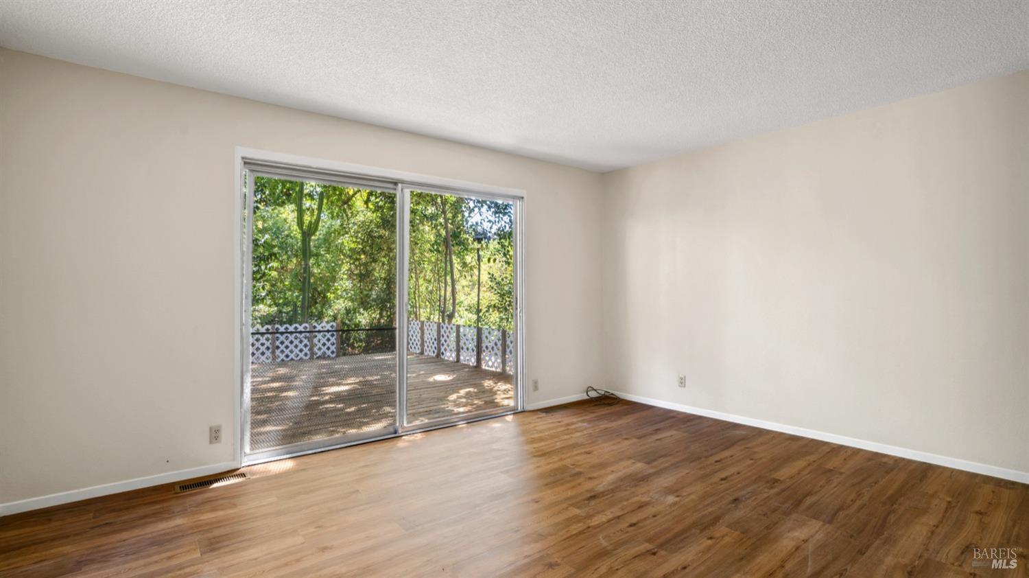 5210-5214 Fulton Road Santa Rosa, CA 95403 - Photo 17 of 60 an empty room with wooden floor and windows