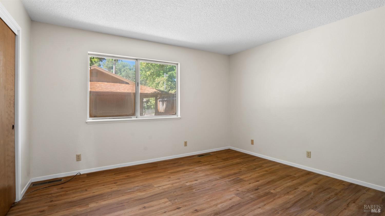 5210-5214 Fulton Road Santa Rosa, CA 95403 - Photo 22 of 60 an empty room with wooden floor and windows