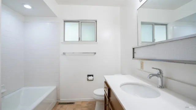 a front view of a house with a garage and balcony