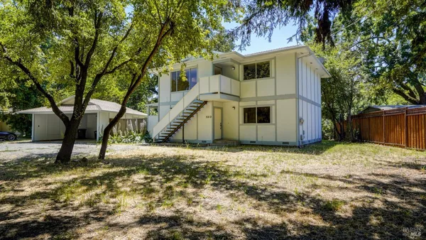 a view of a kitchen with a sink and a refrigerator