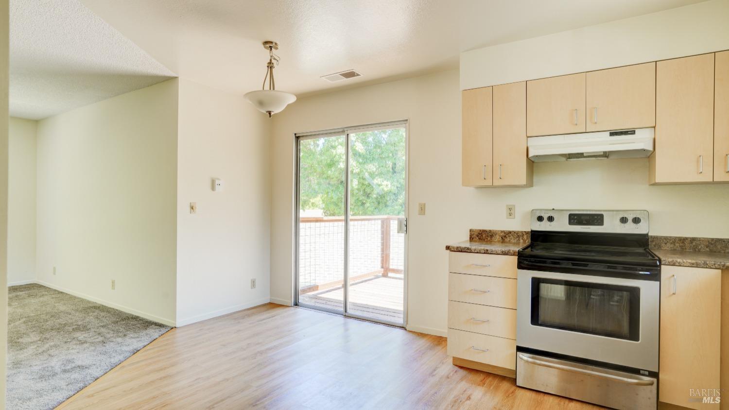 5210-5214 Fulton Road Santa Rosa, CA 95403 - Photo 33 of 60 a kitchen with stainless steel appliances white cabinets and a stove top oven