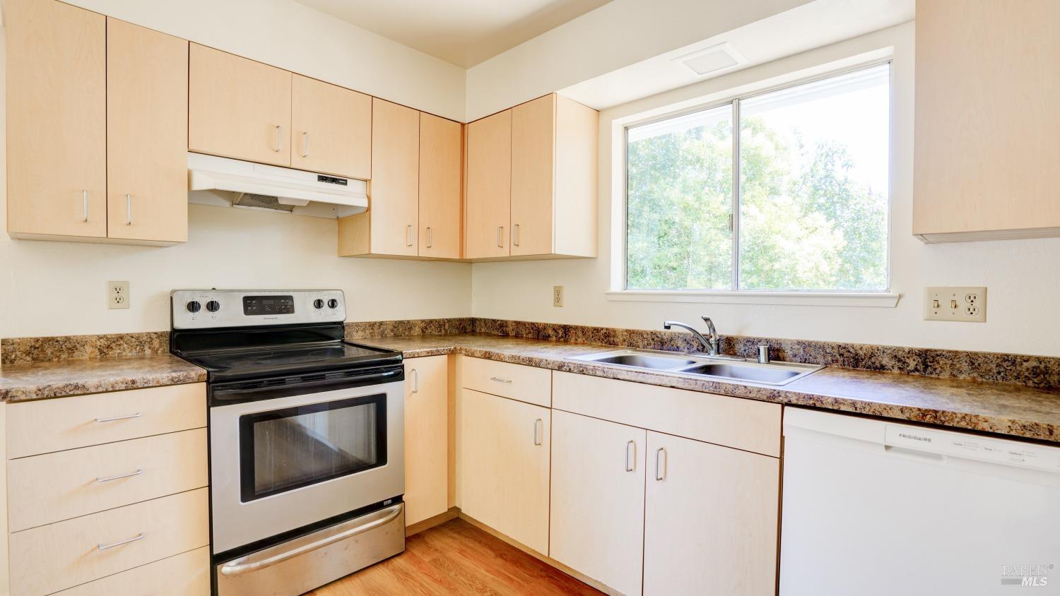 5210-5214 Fulton Road Santa Rosa, CA 95403 - Photo 34 of 60 a kitchen with granite countertop white cabinets appliances and a window