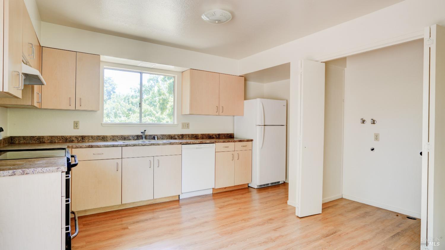 5210-5214 Fulton Road Santa Rosa, CA 95403 - Photo 36 of 60 a kitchen with granite countertop white cabinets and white appliances