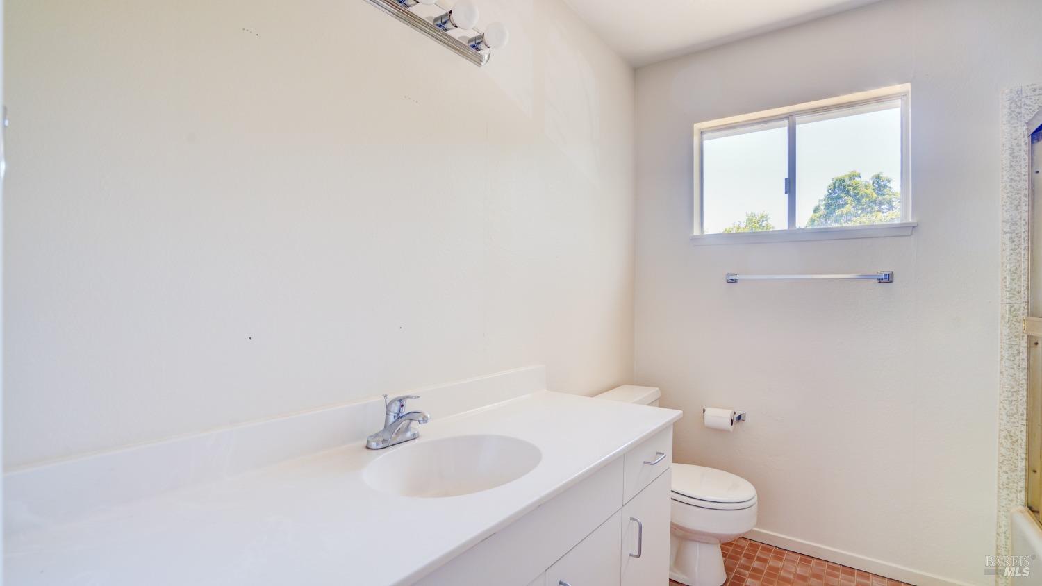 5210-5214 Fulton Road Santa Rosa, CA 95403 - Photo 39 of 60 a bathroom with a sink a toilet and mirror