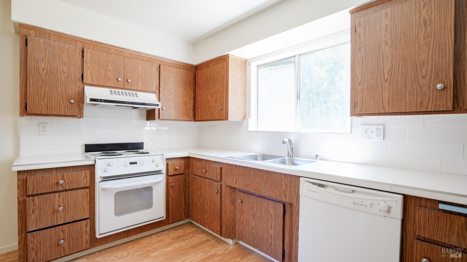 5210-5214 Fulton Road Santa Rosa, CA 95403 - Photo 48 of 60 a kitchen with a sink stove and cabinets