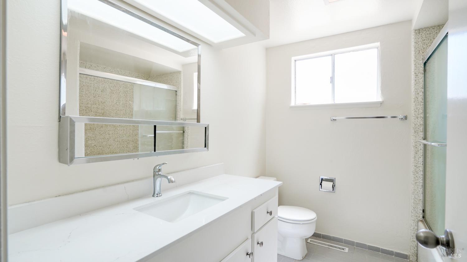 5210-5214 Fulton Road Santa Rosa, CA 95403 - Photo 49 of 60 a bathroom with a sink toilet and mirror