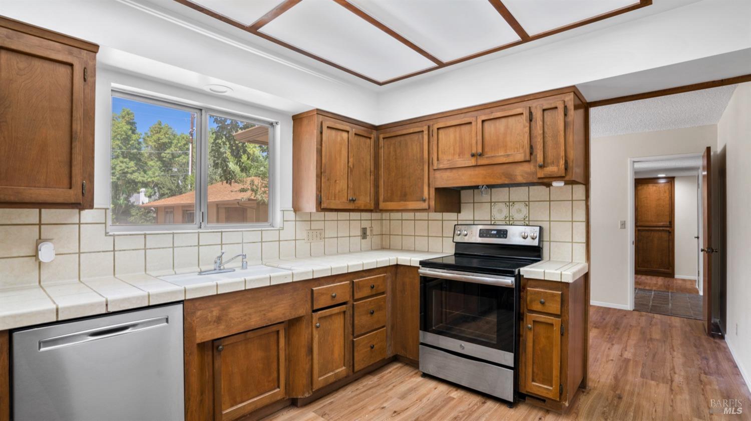 5210-5214 Fulton Road Santa Rosa, CA 95403 - Photo 10 of 60 a kitchen with stainless steel appliances a stove sink and cabinets