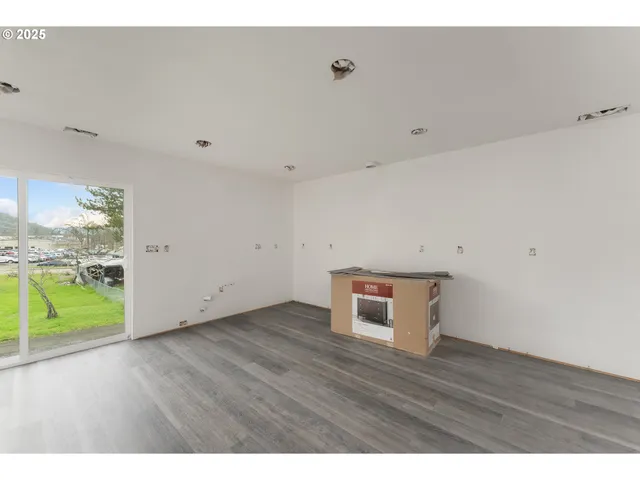 a view of a room with wooden floor