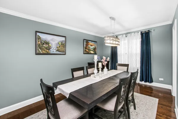 a view of a dining room with furniture window and wooden floor