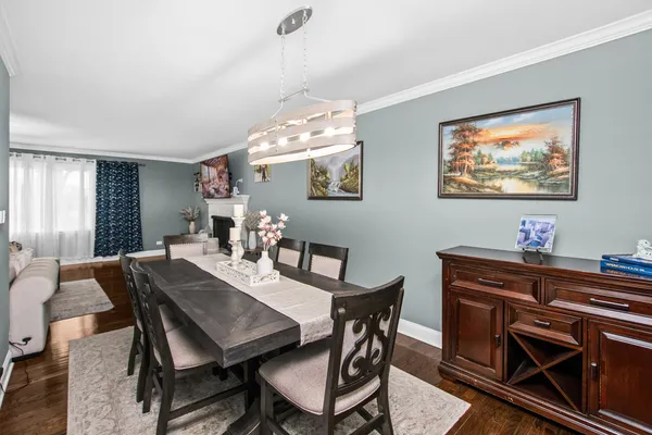 a view of a dining room with furniture and wooden floor