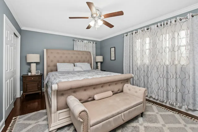 a bedroom with a bed couch and a window