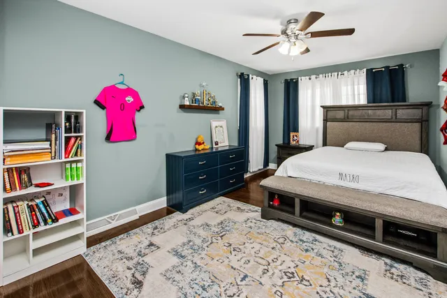 a bedroom with a bed and a book shelf