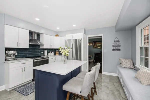 a large kitchen with a table and chairs