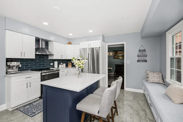 a large kitchen with a table and chairs