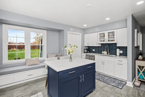 a kitchen with a sink stove and cabinets