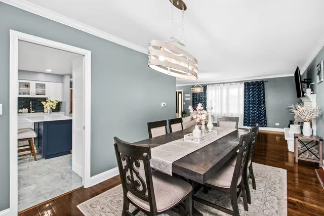 a view of a dining room with furniture and a chandelier