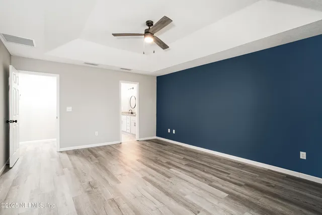 a bedroom with a large bed and a couch