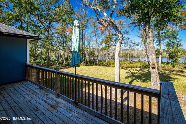 a view of balcony with wooden floor and fence