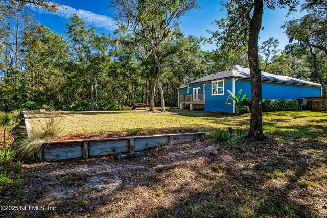 a view of a house with swimming pool and sitting area