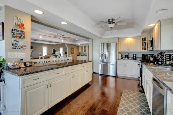 a kitchen with white cabinets and appliances