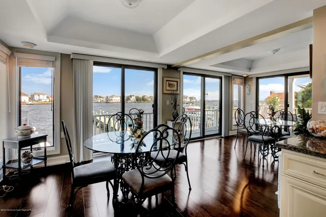 a kitchen with lots of counter and chairs