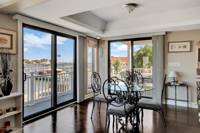 a large kitchen with a lot of counter space and wooden floor