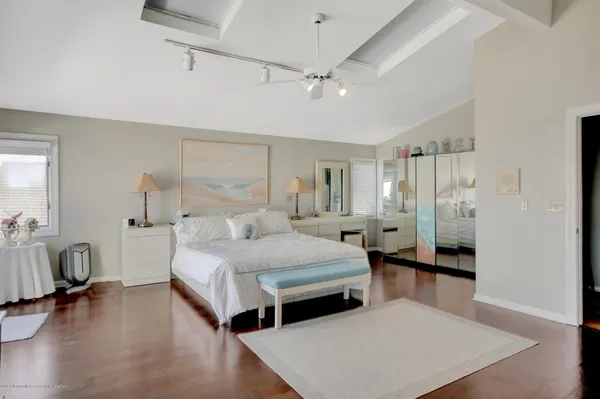 a bathroom with a toilet sink vanity and mirror