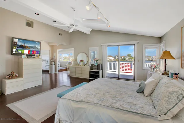 a bedroom with a bed furniture and a book shelf