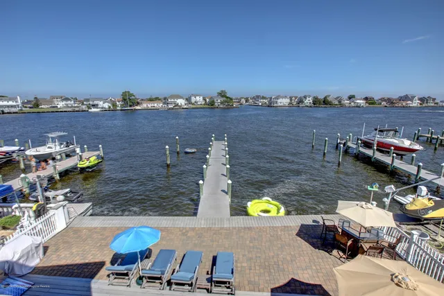 a bathroom with a tub double vanity sink and mirrors