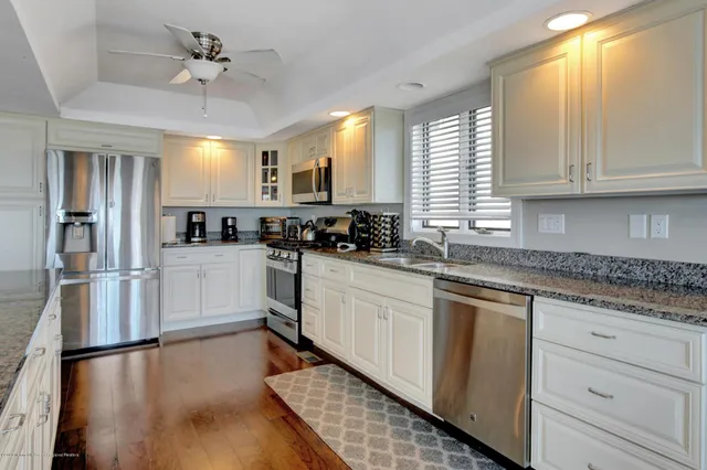 a living room with fireplace furniture and a large window