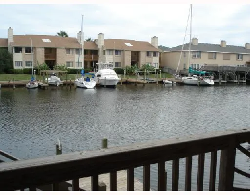 a view of ocean with boats and trees