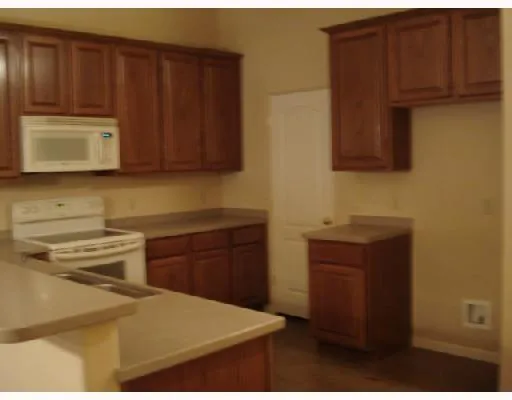 a kitchen with wooden cabinets and a stove top oven