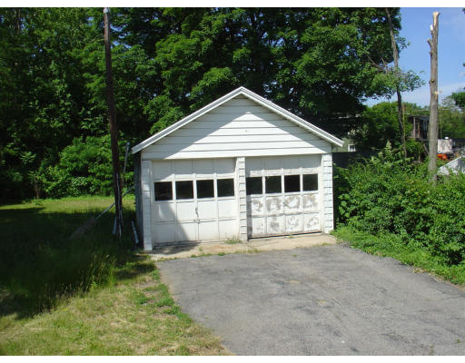 167 Allen Street Springfield, MA 01108 - Photo 6 of 22 a front view of a house with a garden