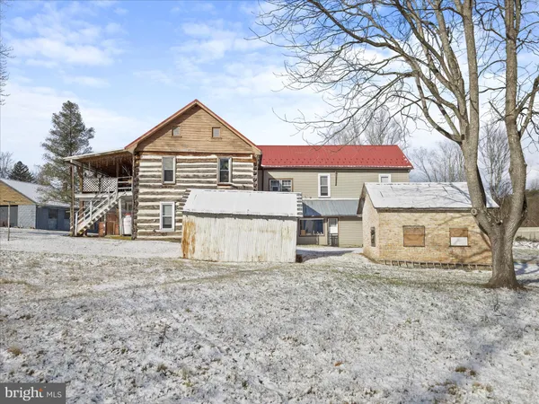 a view of a house with a yard covered in snow