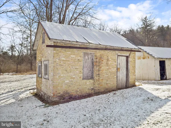 a view of a house with a snow on the road