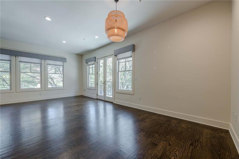 925 Garrett Street, Unit 215 Atlanta, GA 30316 - Photo 11 of 23 a view of an empty room with wooden floor and a window