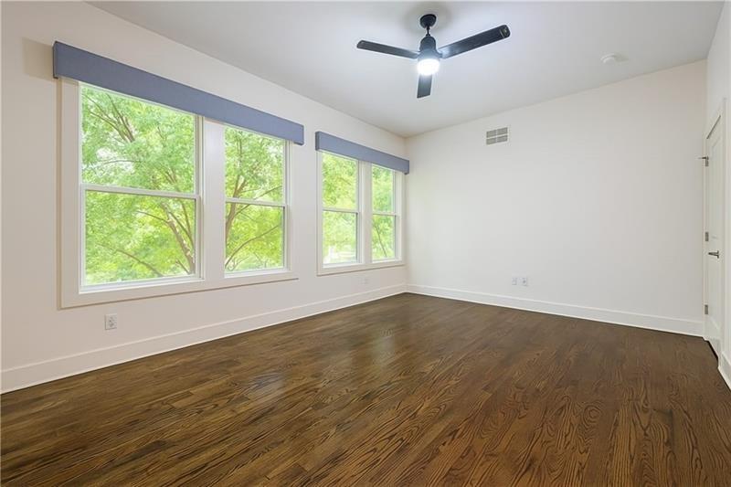 925 Garrett Street, Unit 215 Atlanta, GA 30316 - Photo 12 of 23 a view of an empty room with wooden floor and a window