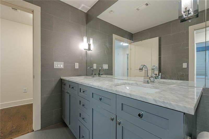 925 Garrett Street, Unit 215 Atlanta, GA 30316 - Photo 13 of 23 a bathroom with a granite countertop sink and a mirror