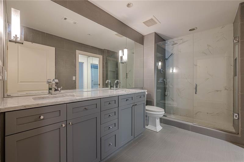 925 Garrett Street, Unit 215 Atlanta, GA 30316 - Photo 14 of 23 a bathroom with a double vanity sink a toilet and a mirror