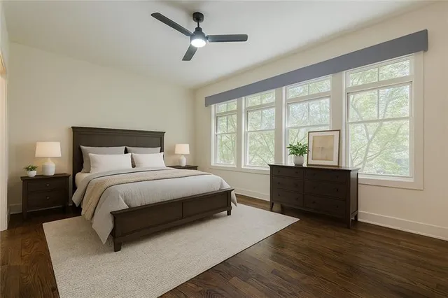 a bedroom with a large bed and a large window