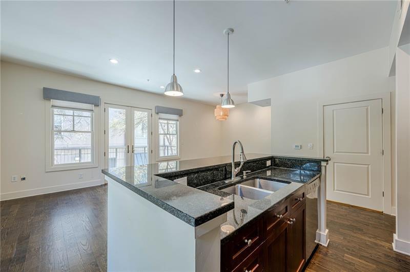 925 Garrett Street, Unit 215 Atlanta, GA 30316 - Photo 8 of 23 a kitchen with a sink stove and wooden floor