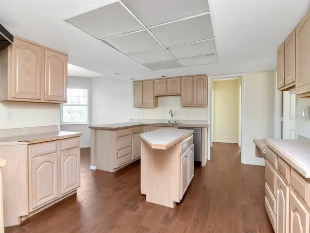 a kitchen with granite countertop a sink and a stove top oven