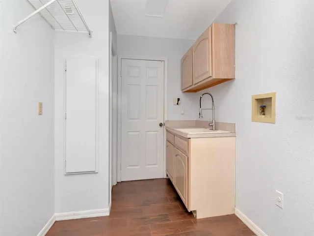 a utility room with cabinets washer and dryer