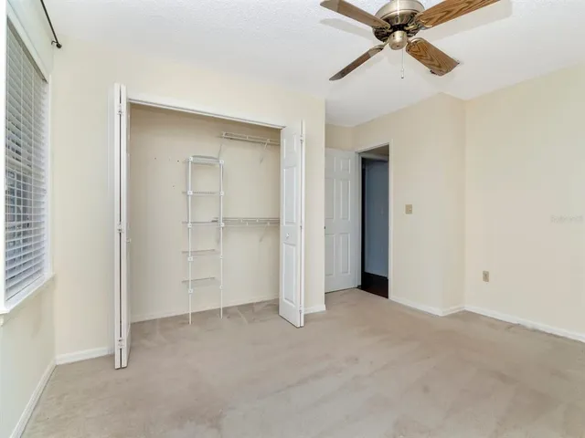 a view of a room with a ceiling fan